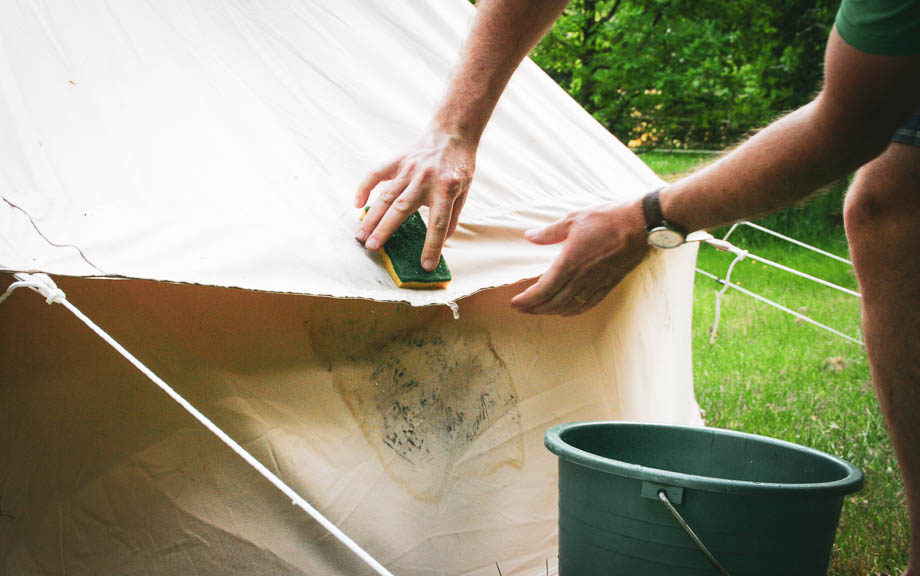 man cleaning a tent